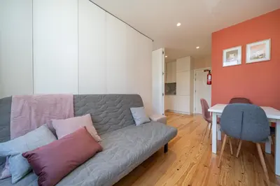 a living room with a couch and a table at Firmeza Apartment by Amber Star Rent in Porto