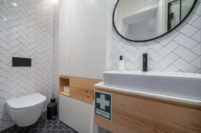 a bathroom with a toilet and a sink and a mirror at Firmeza Apartment by Amber Star Rent in Porto