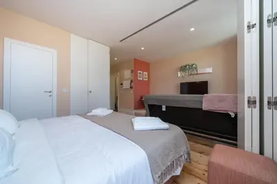 a bedroom with two beds and a television in it at Firmeza Apartment by Amber Star Rent in Porto