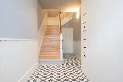 a hallway with stairs and a tile floor at Firmeza Apartment by Amber Star Rent in Porto