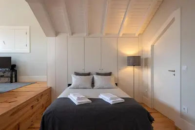a bedroom with a bed with two towels on it at Oporto Rooftop Studio by Vacationy in Porto