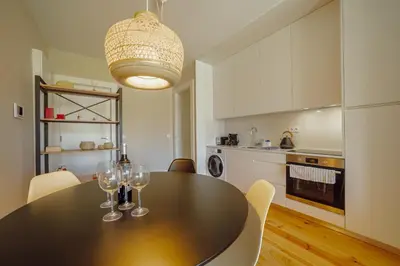 a kitchen with a table with wine glasses on it at Boavista Premium Apartments by Vacationy in Porto
