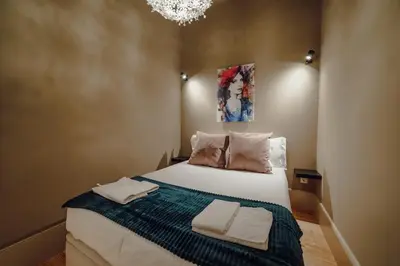 a bedroom with a bed with two towels on it at Legacy Oporto Premium Apartments by Vacationy in Porto