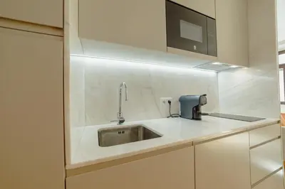 a kitchen with a sink and a microwave at Legacy Oporto Premium Apartments by Vacationy in Porto