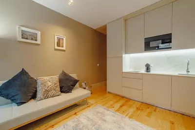 a living room with a couch and a sink at Legacy Oporto Premium Apartments by Vacationy in Porto