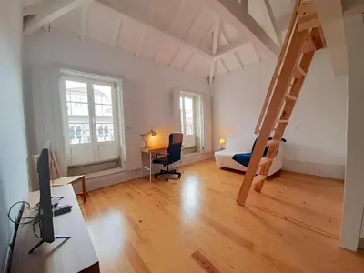 a room with a desk and a bed and a ladder at Porto Vista by Flat in Porto in Porto
