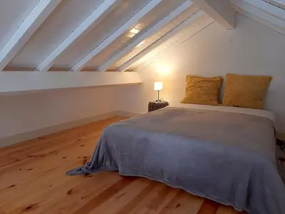 a bedroom with a large bed in a attic at Porto Vista by Flat in Porto in Porto