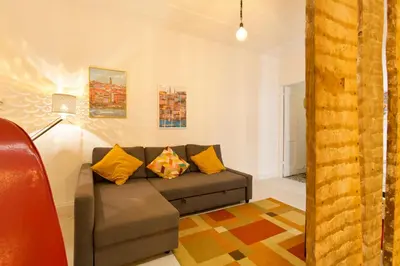 a living room with a couch and yellow pillows at Oporto Blue Vitória - Lovely Citycenter Studio in Porto