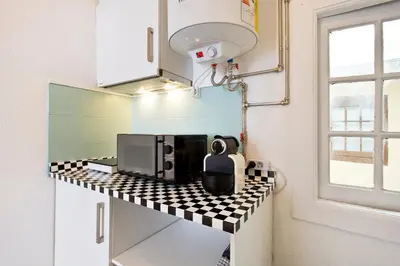 a black and white checkered counter in a kitchen at Oporto Blue Vitória - Lovely Citycenter Studio in Porto