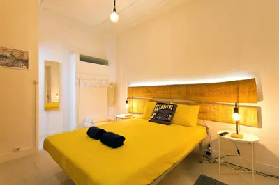 a bedroom with a yellow bed with two pillows on it at Oporto Blue Vitória - Lovely Citycenter Studio in Porto