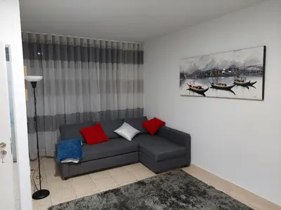a living room with a couch with red and blue pillows at charming loft in Porto in Porto