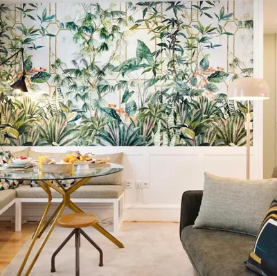 a living room with a table and a mural of plants at Away to Enjoy Apartment - hapiness has a place in Porto