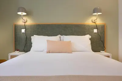 a large bed with two lights on top of it at Away to Enjoy Apartment - hapiness has a place in Porto