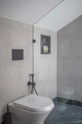 a bathroom with a white toilet and a shower at 62 Design House II in Porto