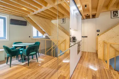 a dining room with a table and green chairs at 62 Design House II in Porto