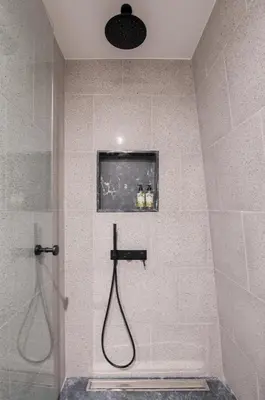 a shower with a hose in a bathroom at 62 Design House II in Porto