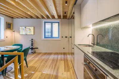 a kitchen and dining room with a table and chairs at 62 Design House II in Porto