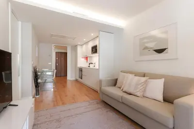 a living room with a couch and a kitchen at HM - Casa Ghiselini Porto 215 in Porto