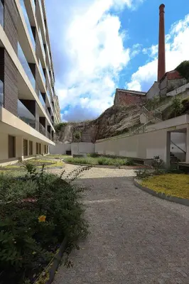 a building with a tower on a hill in the background at HM - Casa Ghiselini Porto 215 in Porto
