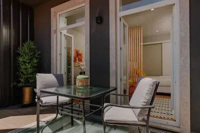 a dining room with a table and two chairs at Green Garden Luxury House w/ AC, Metro & Downtown in Porto
