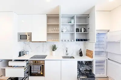 a white kitchen with white cabinets and appliances at Paraíso 1H w/ AC by LovelyStay in Porto