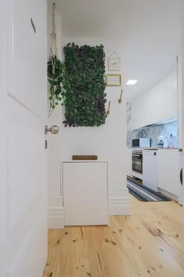 a kitchen with white walls and a green wall at Cedofeita Charming Flat in Porto