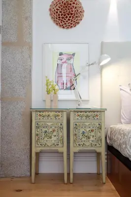 a bedroom with a table with a lamp and a bed at Cedofeita Charming Flat in Porto