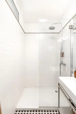 a white bathroom with a shower and a sink at VIVA Old Street Homes in Porto