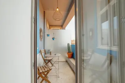 a hallway with a table and chairs in a room at Downtown Modern Studio With Terrace by Vacationy in Porto