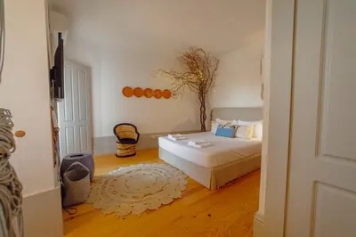 a bedroom with a bed and a tree on the wall at Downtown Modern Studio With Terrace by Vacationy in Porto