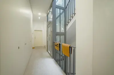 a hallway with towels hanging on a metal railing at Downtown Modern Studio With Terrace by Vacationy in Porto