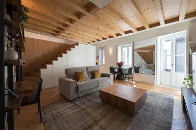 a living room with a couch and a table at Flores City Retreat in Porto