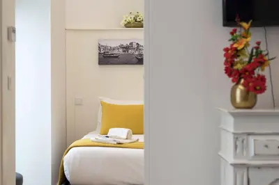 a bedroom with a bed with a yellow pillow at Santo António Oporto House in Porto