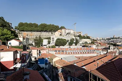 a view of a city with roofs and buildings at Stunning Duplex Near River by LovelyStay in Porto