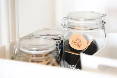 a shelf with jars of food in a drawer at Alegria Cool House in Porto