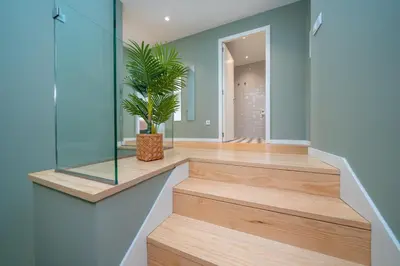 a hallway with a staircase with a potted plant at Trindade Duplex by Amber Star Rent in Porto