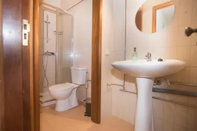 a bathroom with a sink and a toilet at Bonsai Apartment III in Porto