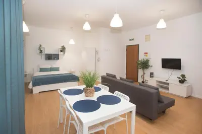 a living room with a couch and a table and a bed at Bonsai Apartment III in Porto