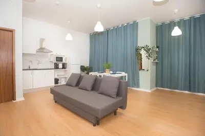 a living room with a couch and a kitchen at Bonsai Apartment III in Porto