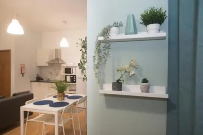 a kitchen and a dining room with a table with plants at Bonsai Apartment III in Porto