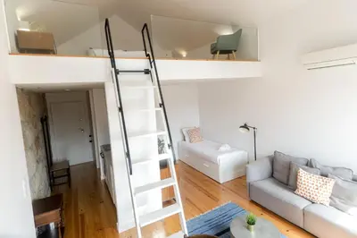 a room with a loft bed and a couch at Loft Martires da Liberdade by Porto City Hosts in Porto