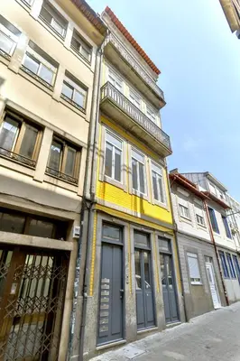a building with a yellow trim on a street at Loft Martires da Liberdade by Porto City Hosts in Porto