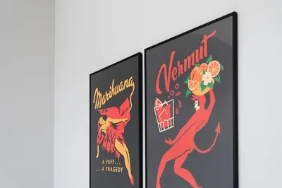 a pair of framed posters of a red superhero at GuestReady - Colorful Apt near Agosto Station in Porto