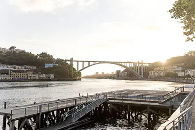 a bridge over a river next to a city at Wonderful 2BR Duplex Near River by LovelyStay in Porto