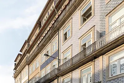 a building with a balcony on the side of it at Palácio das Cardosas Studio by LovelyStay in Porto