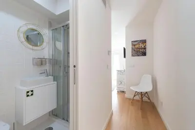 a white bathroom with a sink and a mirror at 31 de Janeiro Oporto House in Porto