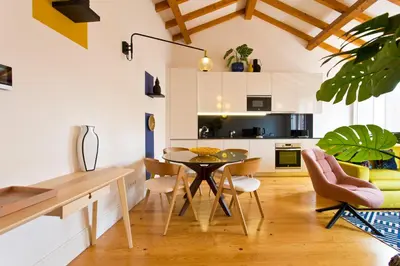 a kitchen and dining room with a table and chairs at BOUTIQUE Rentals-THE ALMA Apt w/ balcony in Porto
