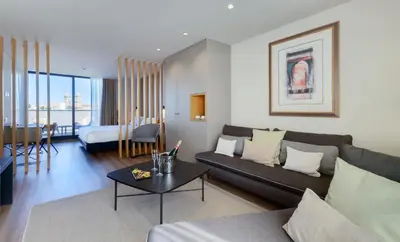 a hotel room with two beds and a window at room Select Porto in Porto