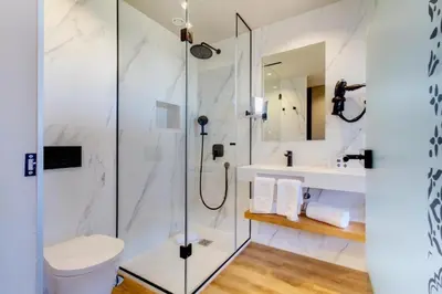 a bedroom with a large white bed and a mirror at room Select Porto in Porto