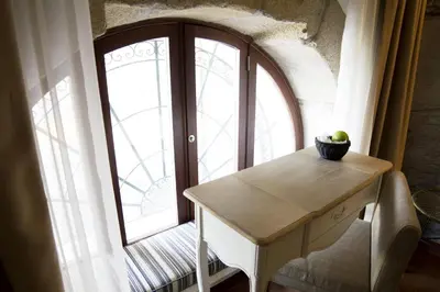 a room with a table and a large window at Oca Ribeira do Porto Hotel in Porto